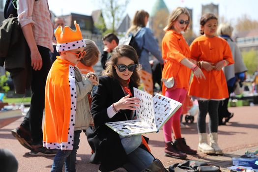 Oranje versierd centrum van Denieuws tijdens koningsdag 2026 met vlaggen, kramen en bezoekers